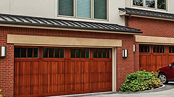 Wood Overlay Carriage House, Model 5432 shown in cedar, field stained with optional madison window designs and seeded glass.